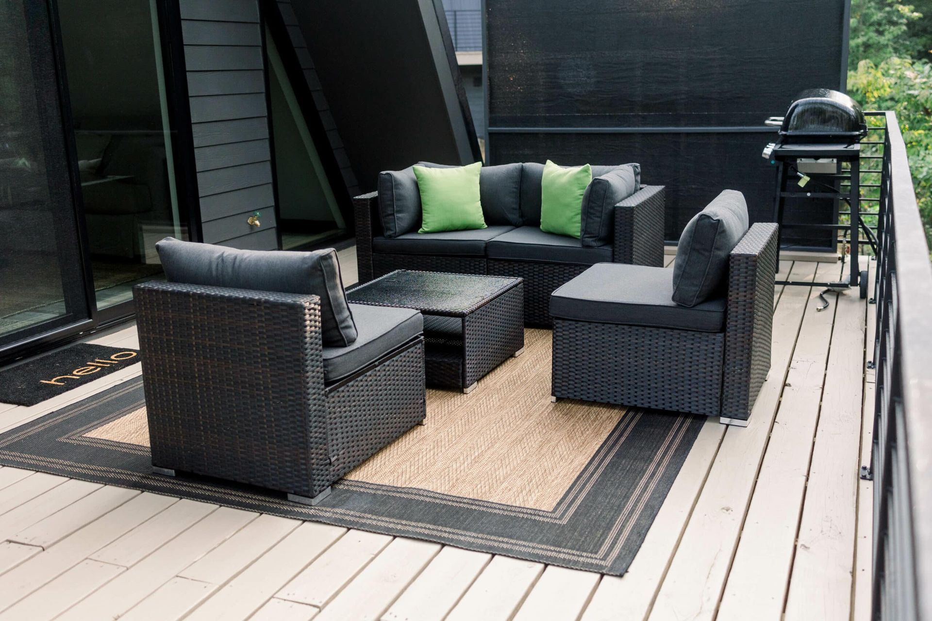 A deck with a couch and chairs on it