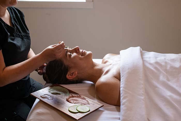 A woman is getting a facial treatment at a spa.