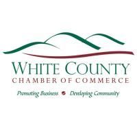 The white county chamber of commerce logo is a green and red logo with mountains in the background.