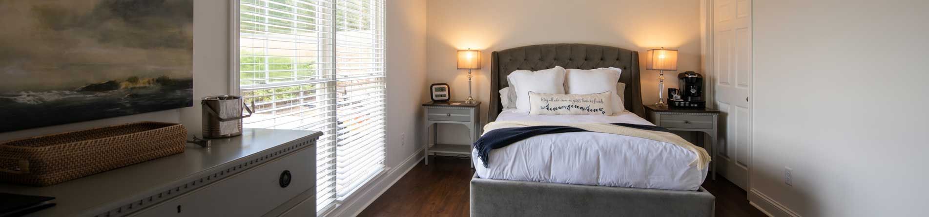 A bedroom with a single bed and a dresser.
