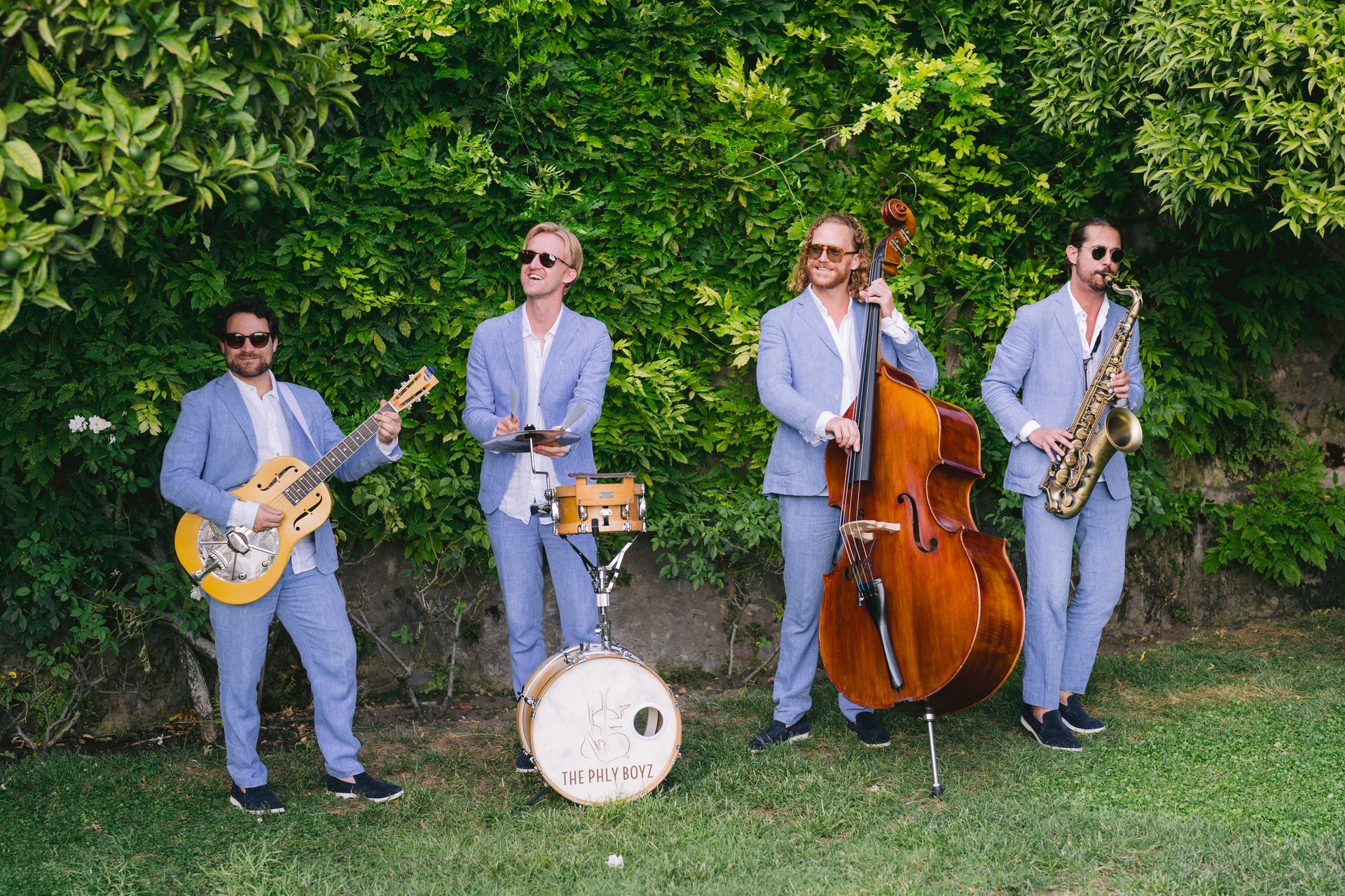 A group of men in suits are playing instruments in a band.