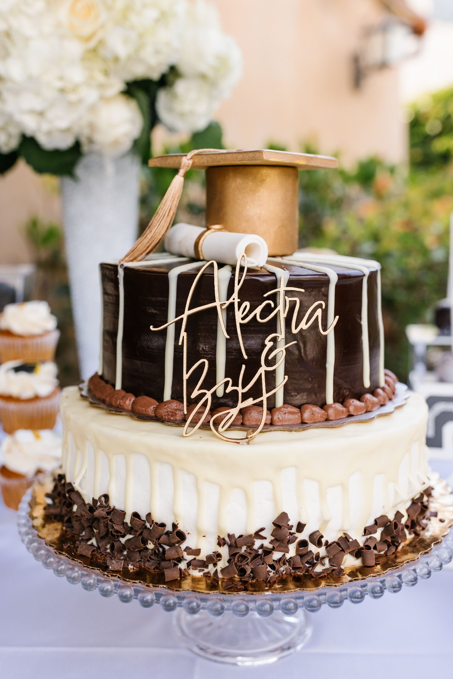 A cake with a graduation cap and diploma on top of it.