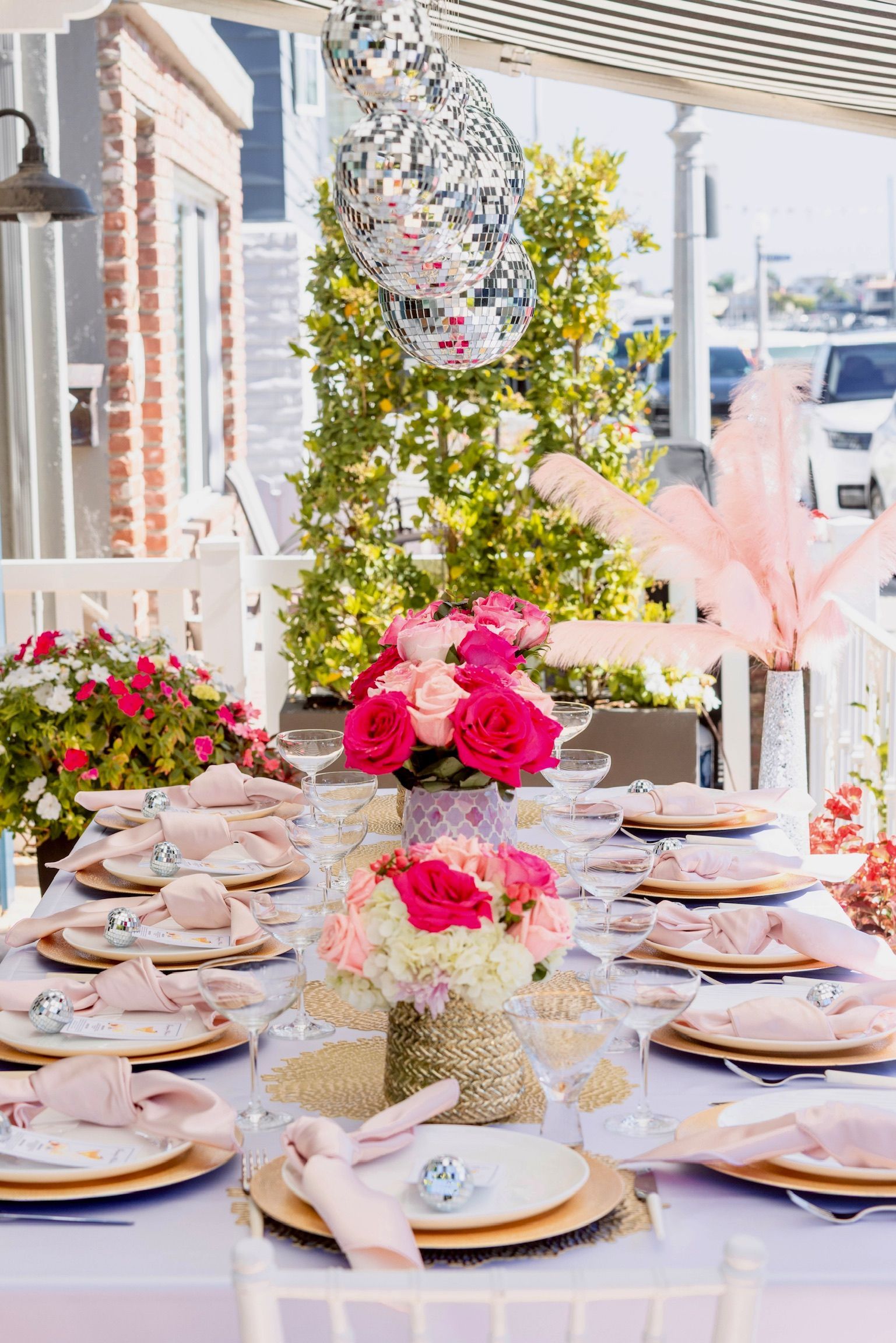 A long table with plates and flowers on it.