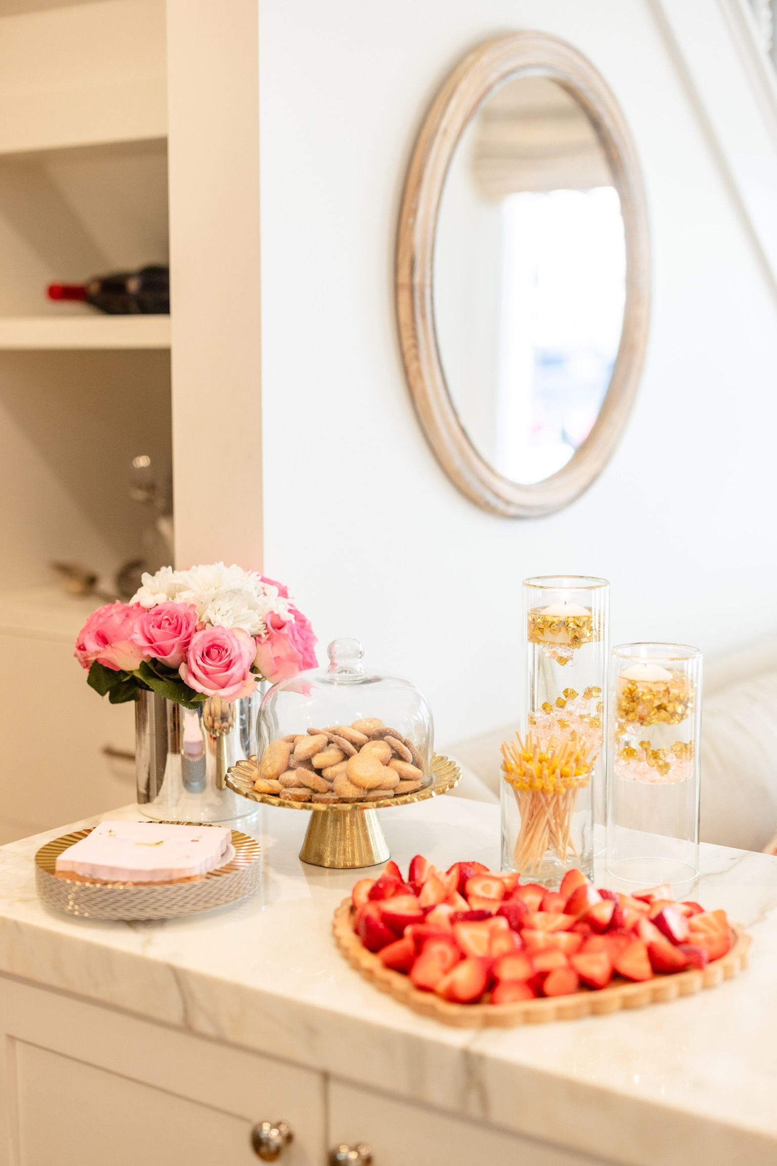 A table with a pie and strawberries on it and a mirror.