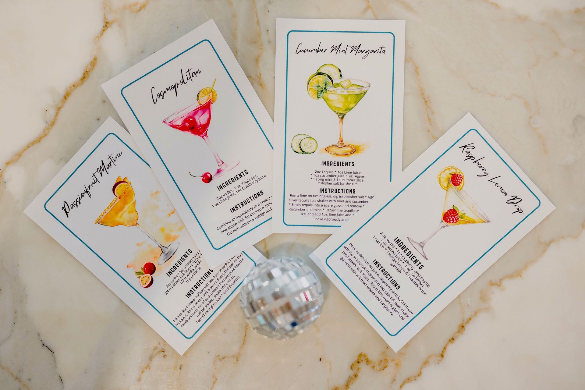 Four cards with different types of drinks on them are sitting on a table.