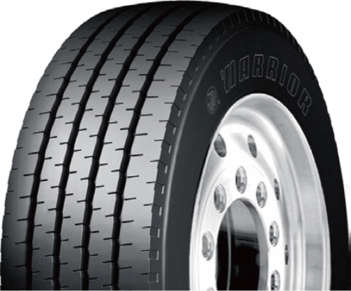 A row of semi trucks are parked in a parking lot