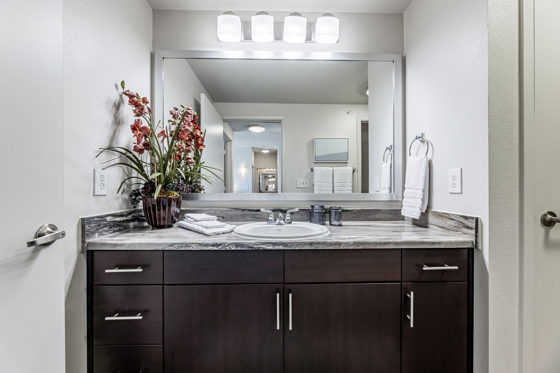 Parkside at Craig Ranch bathroom with a double sink and a large mirror.