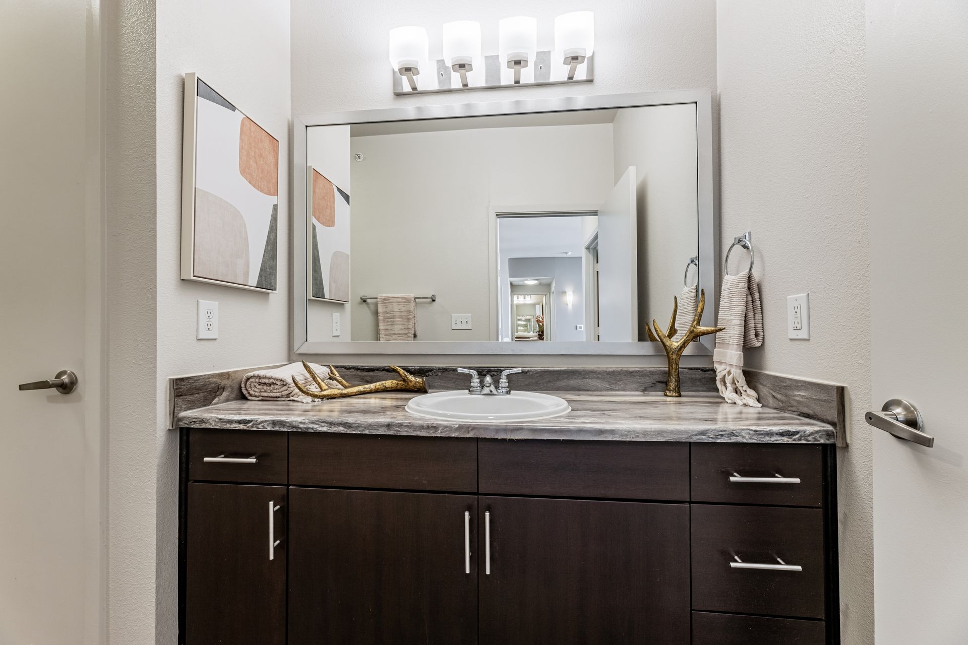 Parkside at Craig Ranch bathroom with a sink, mirror, and cabinets.