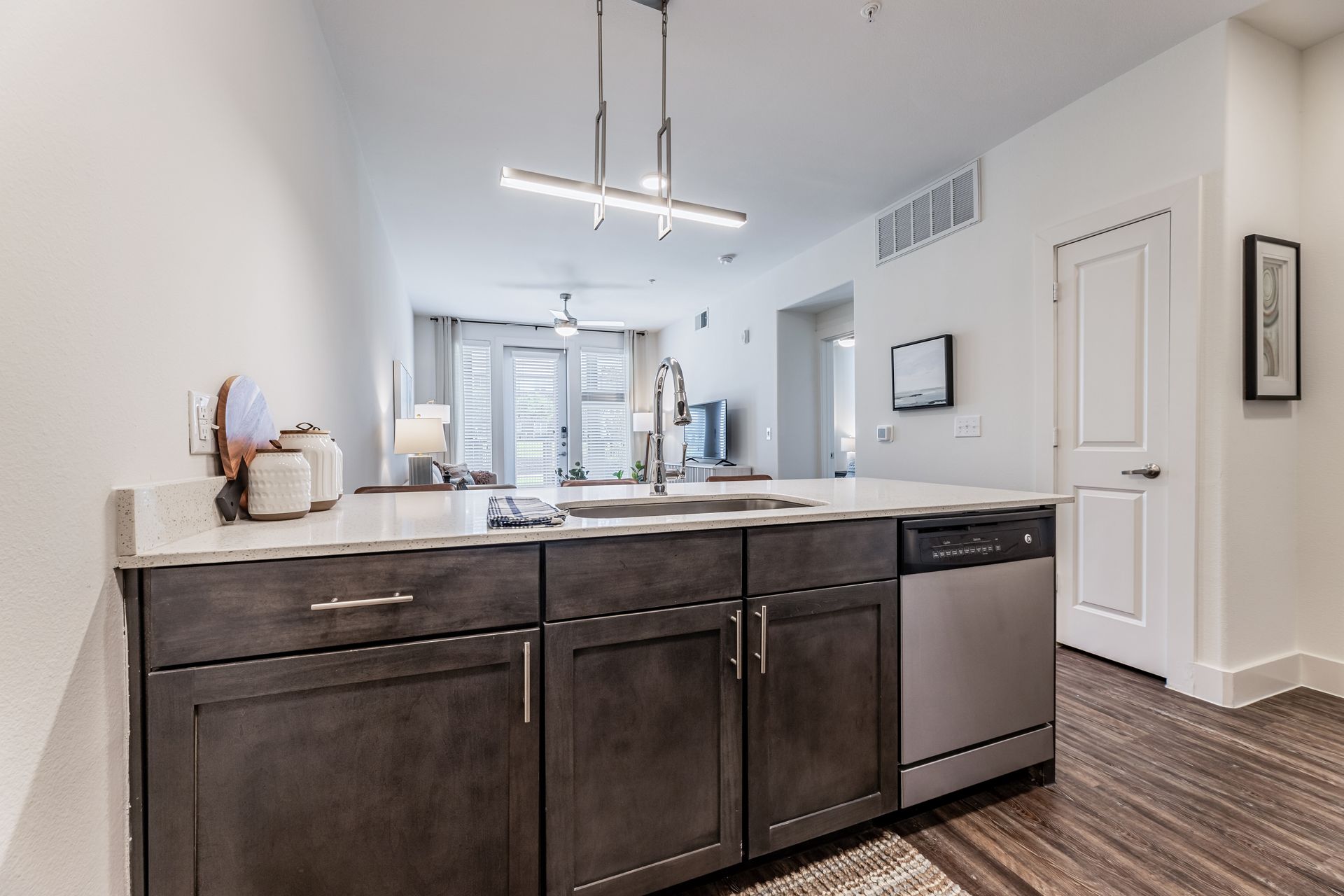 A kitchen with a sink, dishwasher, and stainless steel appliances at Parkside at Craig Ranch.