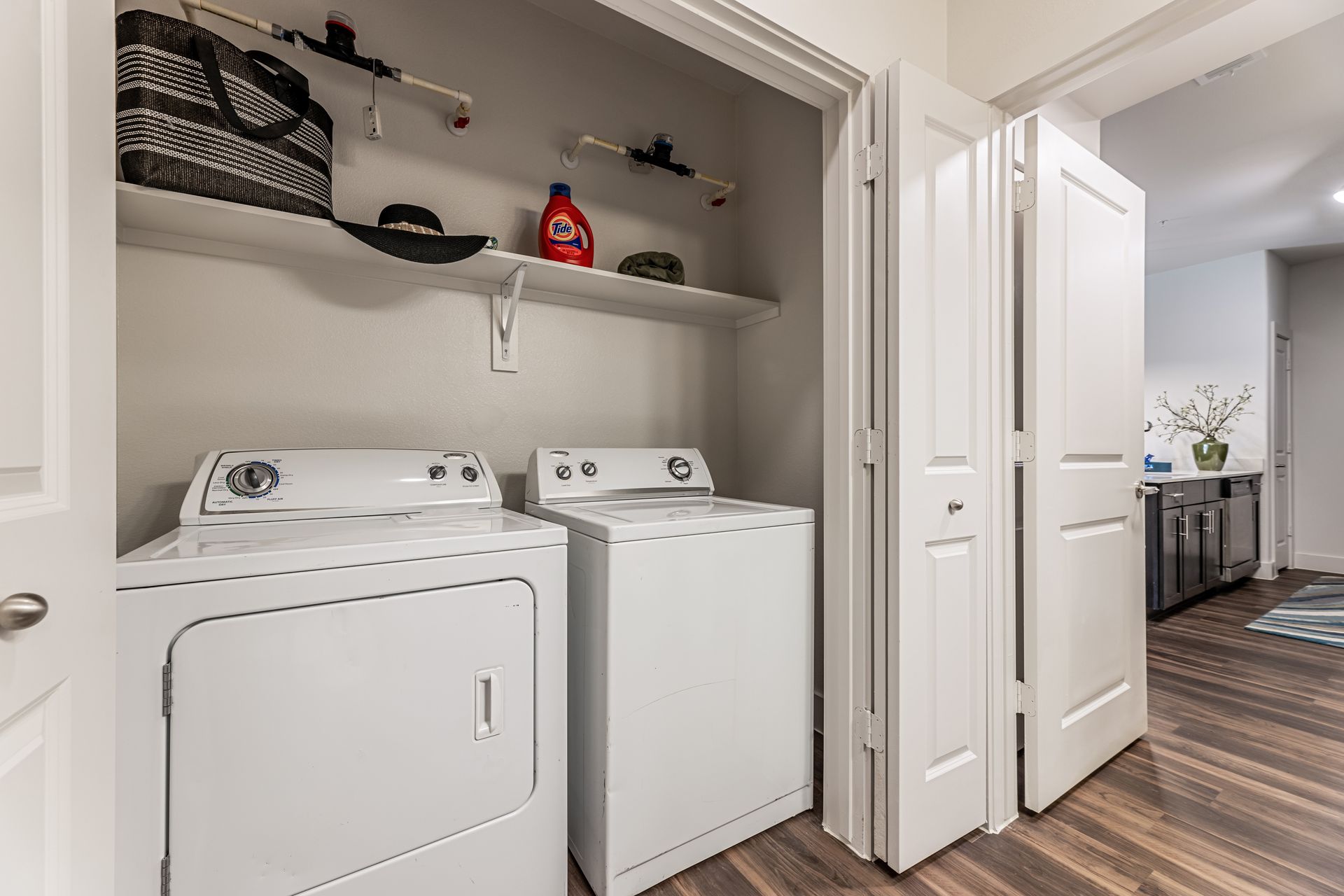A laundry room with a washer and dryer in a closet.