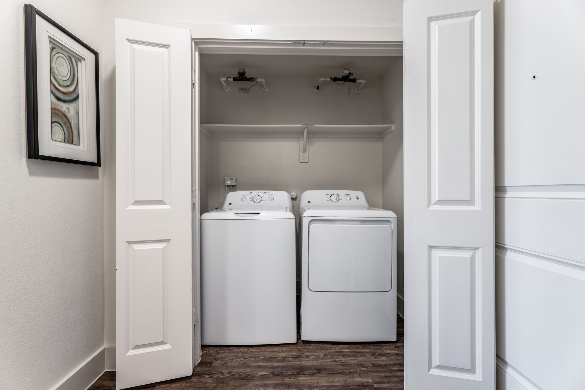 A laundry room with a washer and dryer in a closet at Parkside at Craig Ranch.