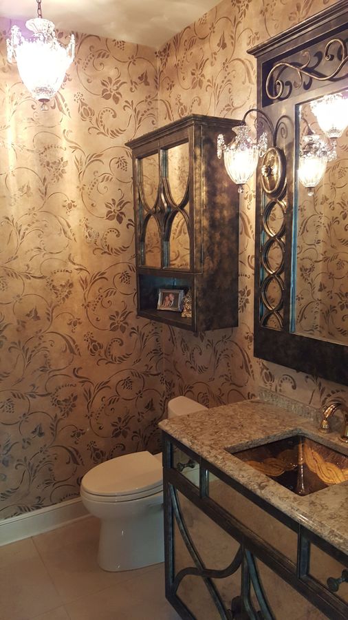 A bathroom with a toilet , sink and mirror.