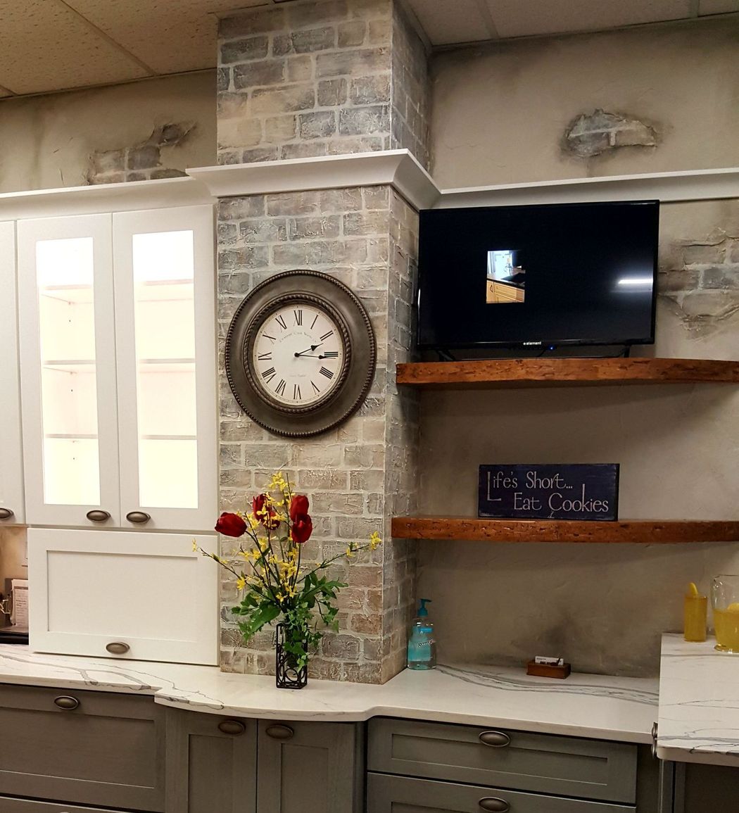 A kitchen with a clock on the wall and a sign that says i love 1st looks