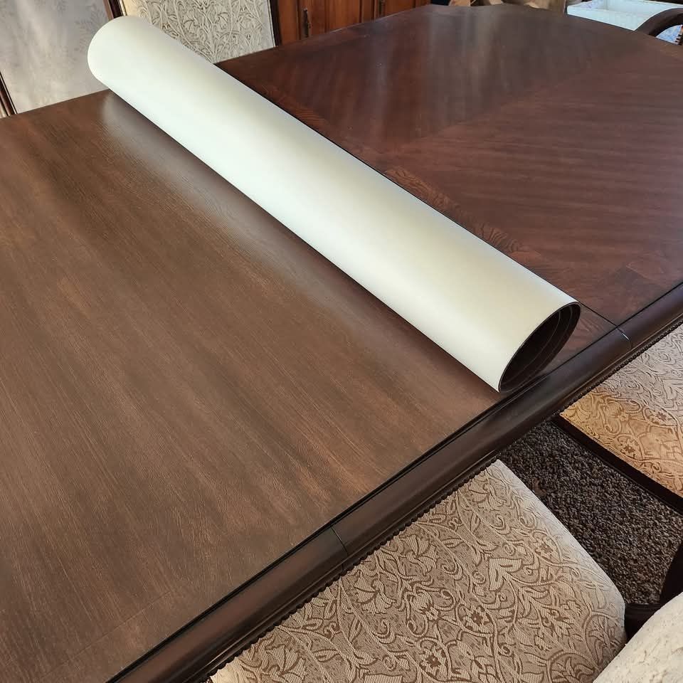 A piece of paper is rolled up on a wooden table