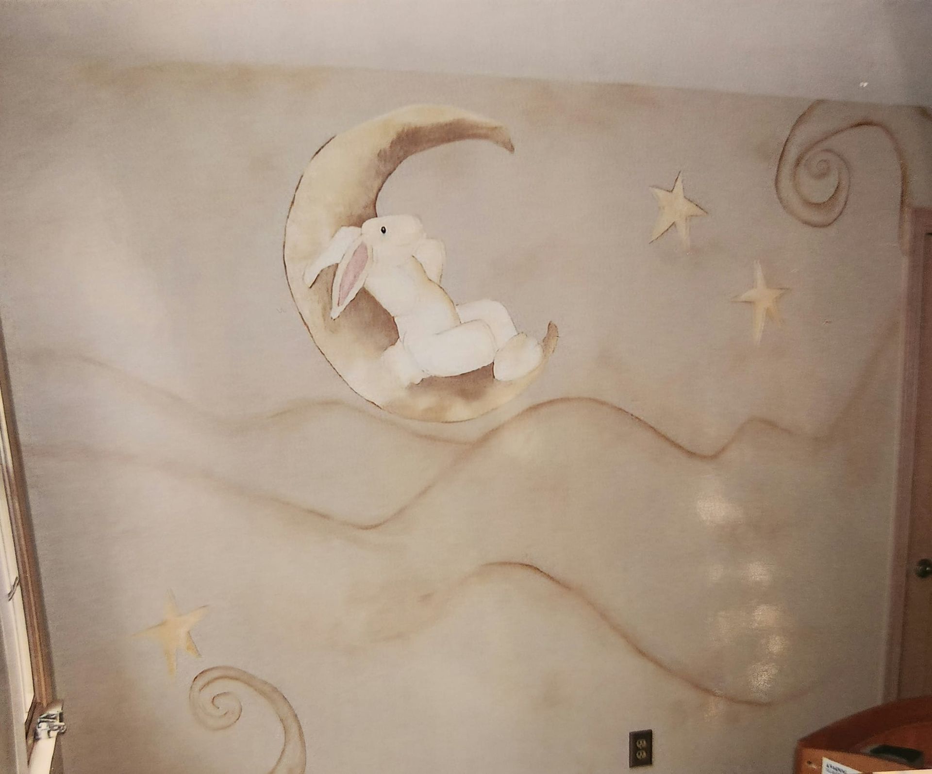 A painting of a rabbit sitting on a crescent moon artist kids room