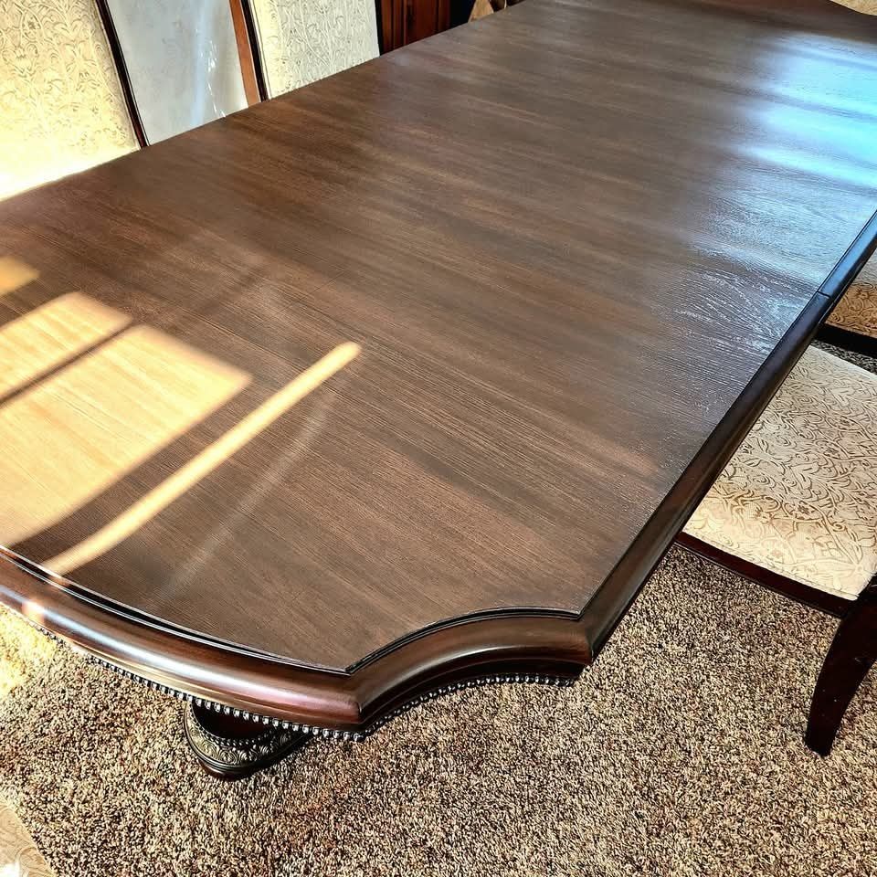 A wooden table is sitting on a carpeted floor
