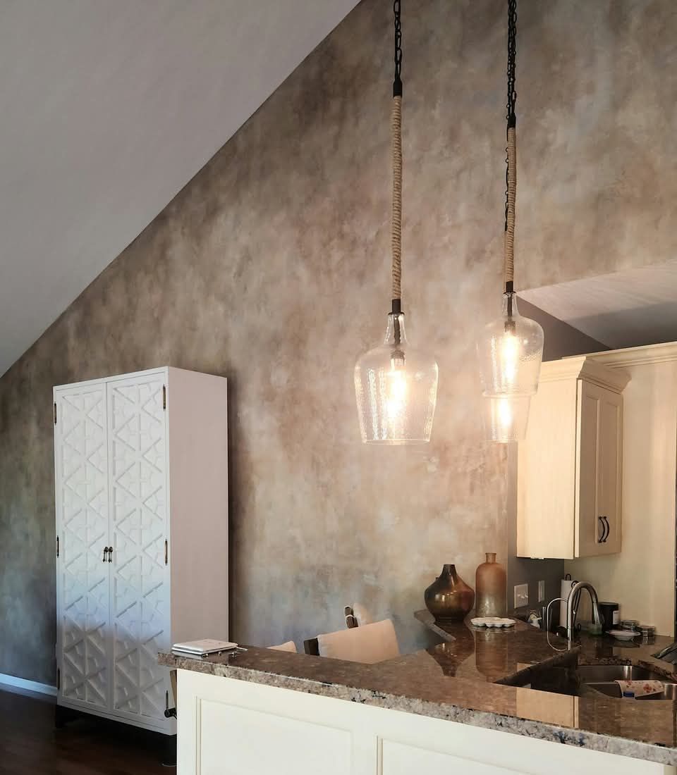 A kitchen with two pendant lights hanging from the ceiling wall technique