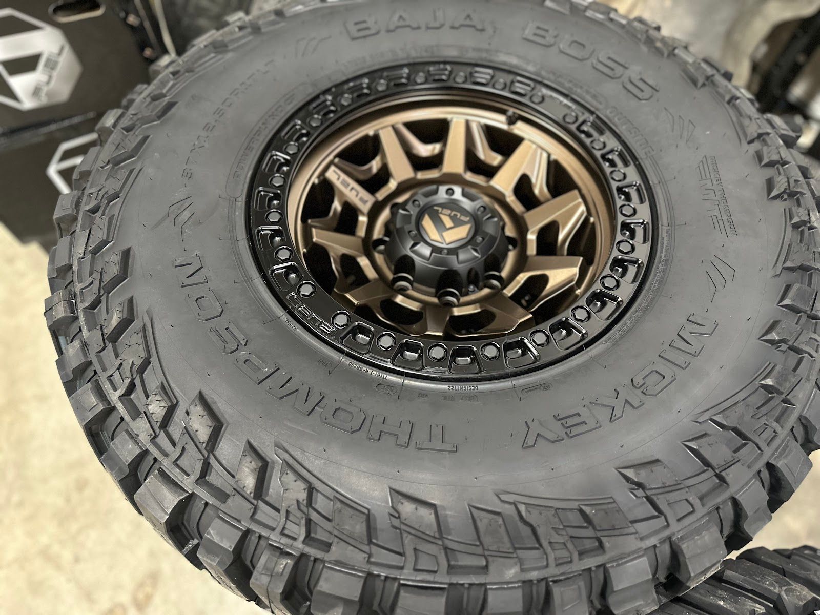 Black and bronze off-road tire and wheel. The tire is a Mickey Thompson Baja Boss on a Fuel wheel.