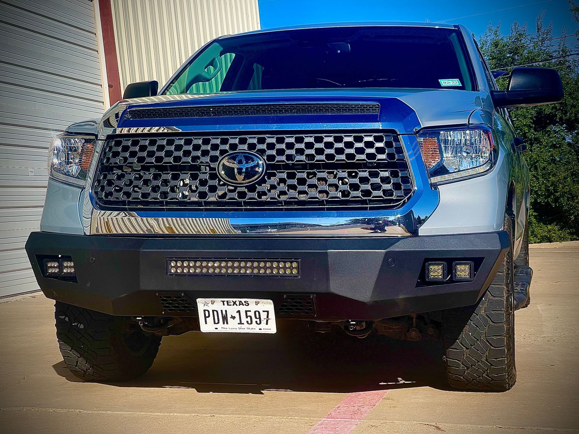 a toyota tundra with a texas license plate is parked in a parking lot .