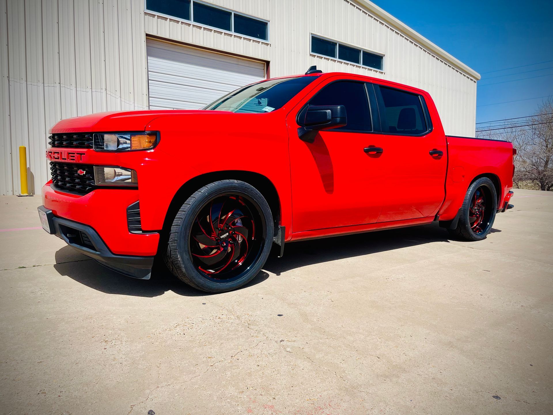 a red truck is parked in front of a building .