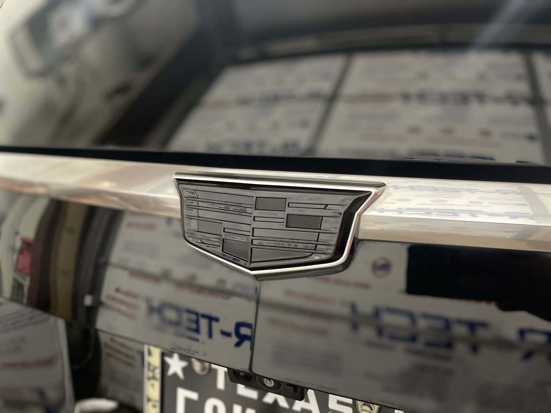 a close up of a cadillac emblem on the back of a car