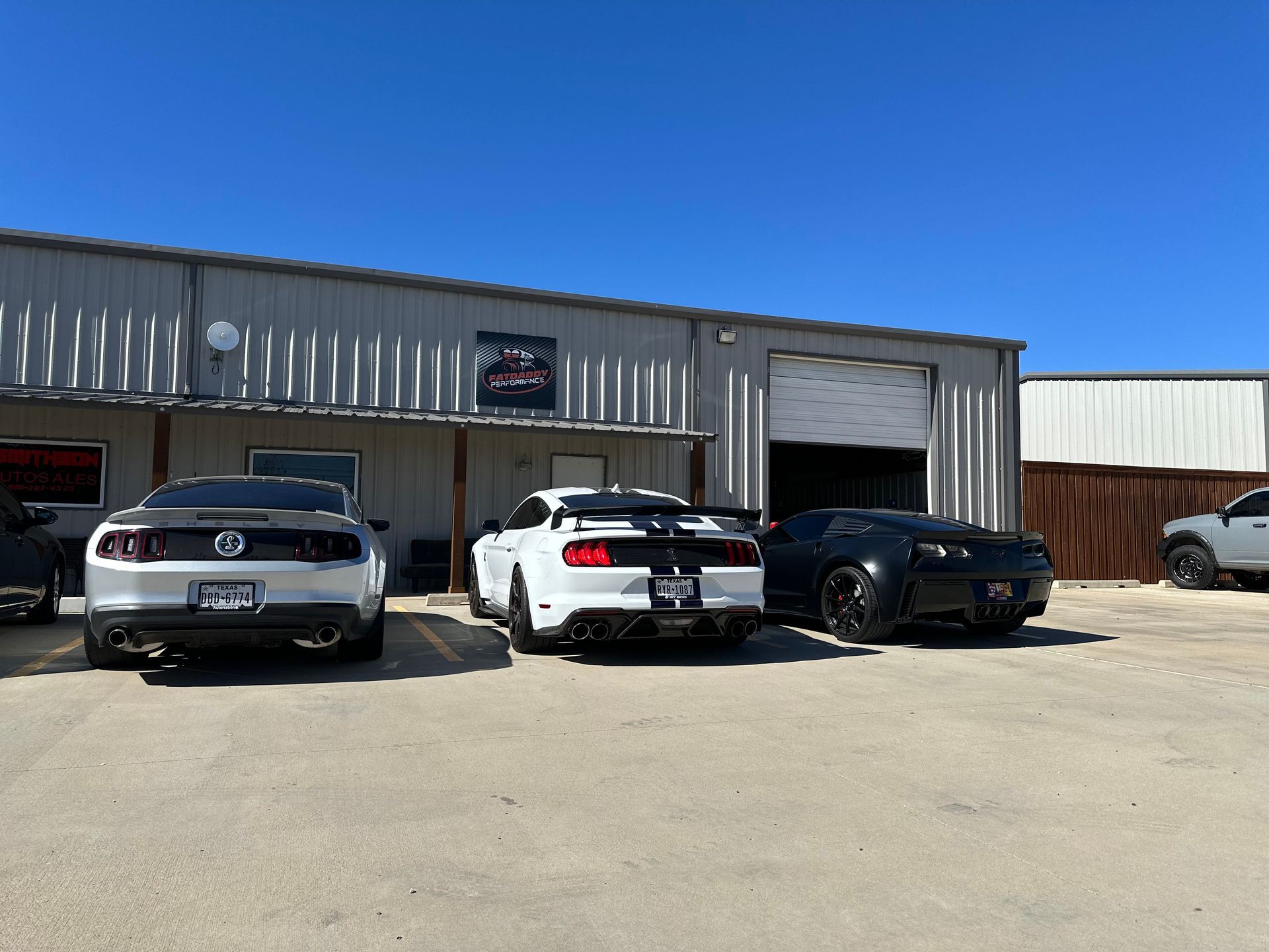 a group of cars are parked in front of a building .