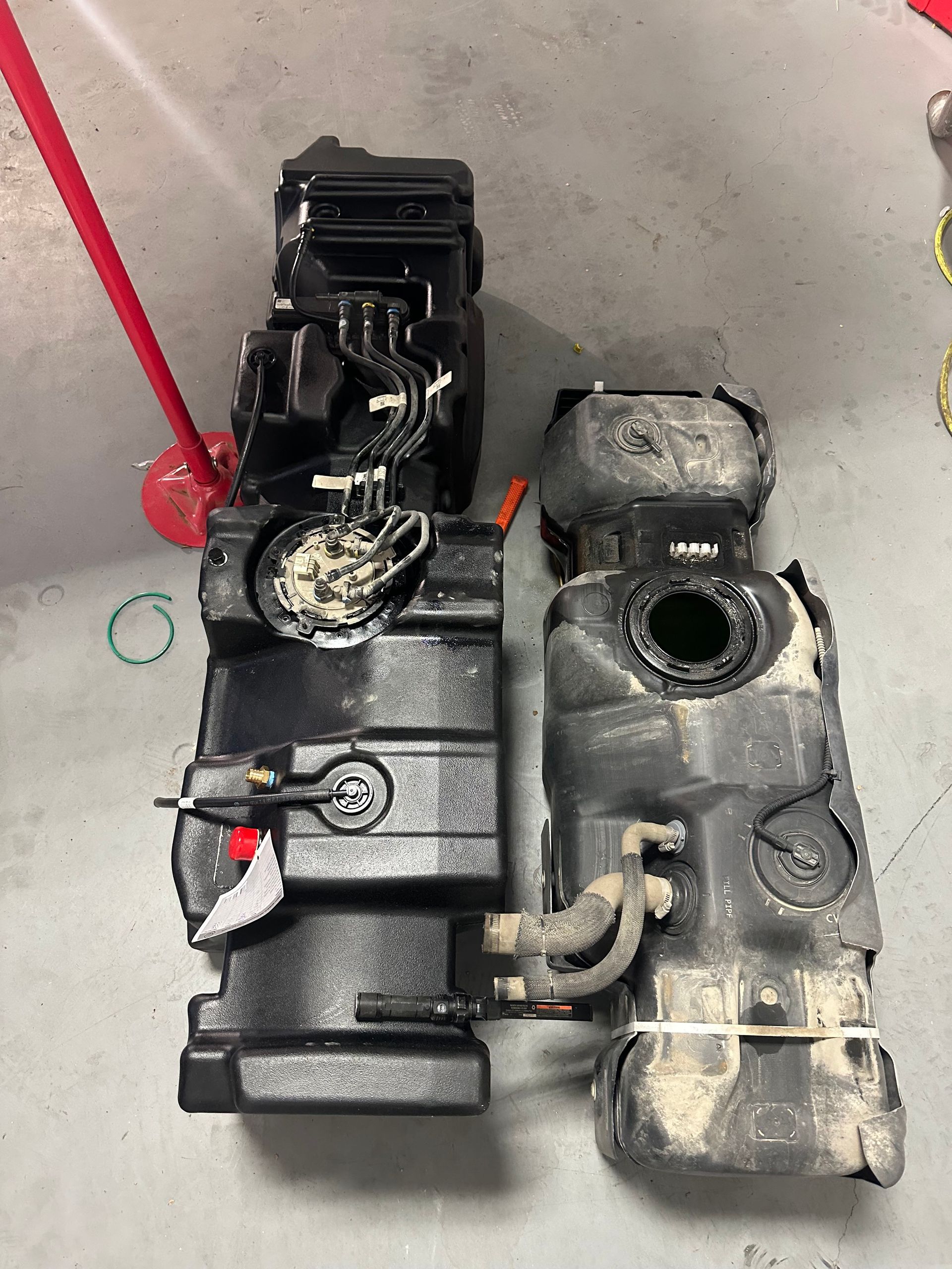 two fuel tanks are sitting next to each other on the floor .