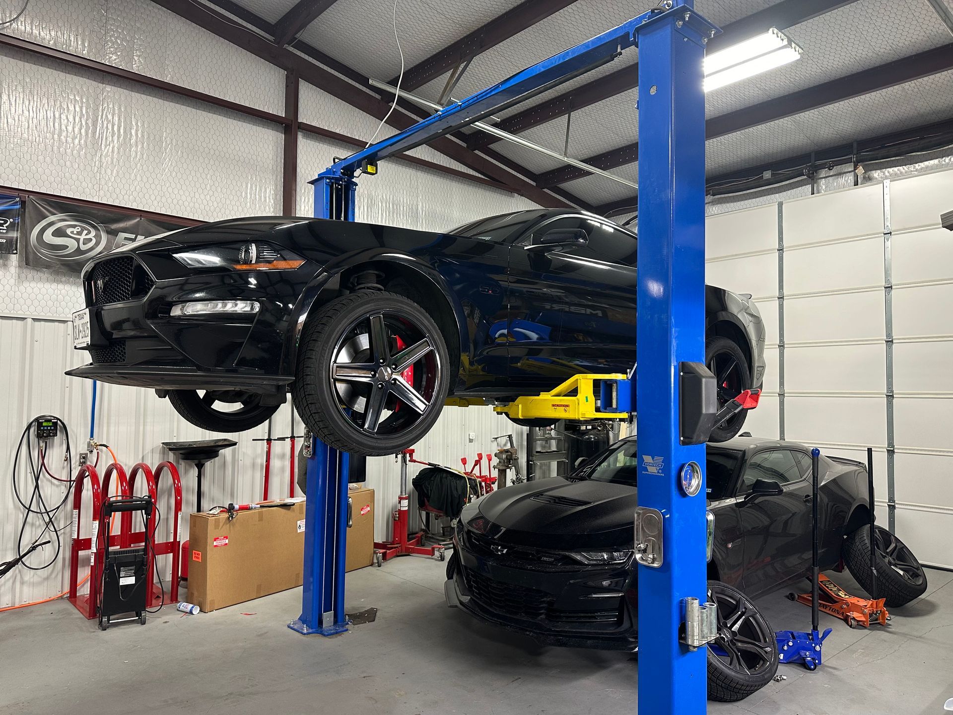 black sports car on lifts