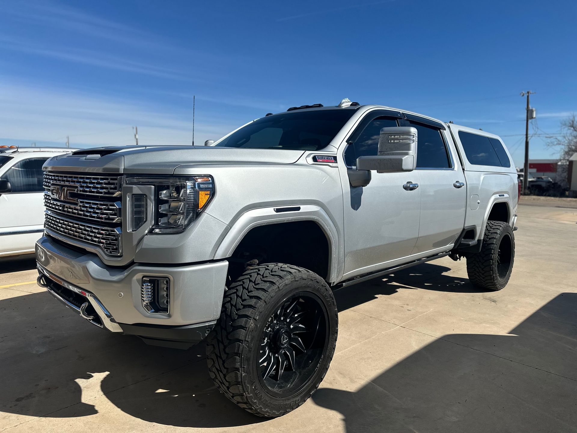 a white gmc sierra 2500 suv is parked in a parking lot .