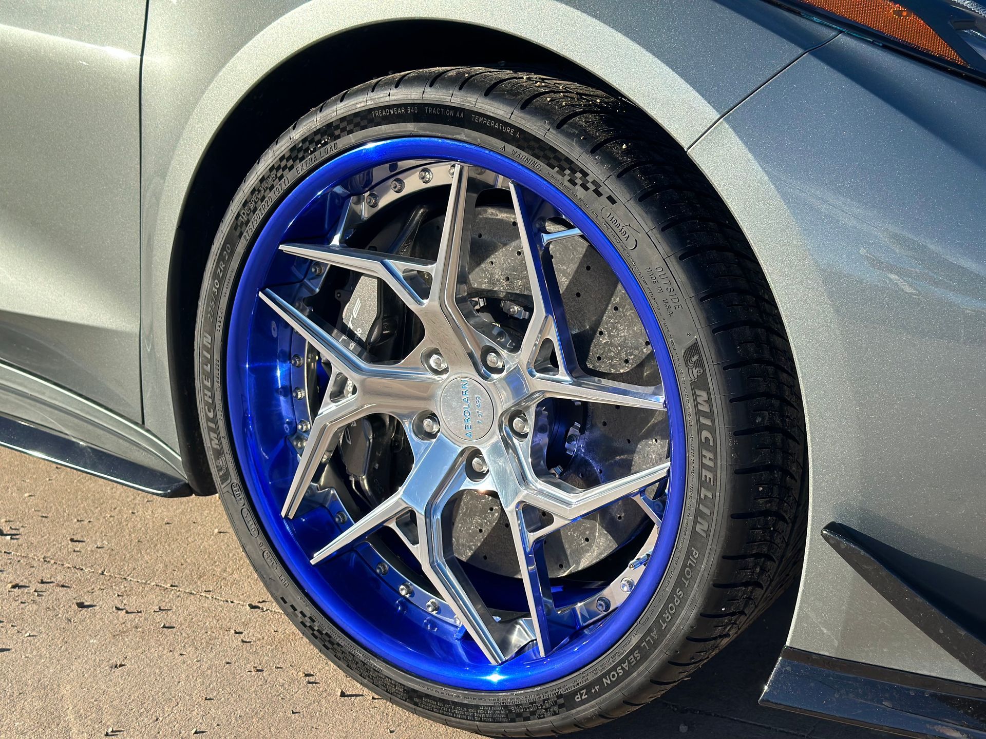 a close up of a car wheel with blue rims