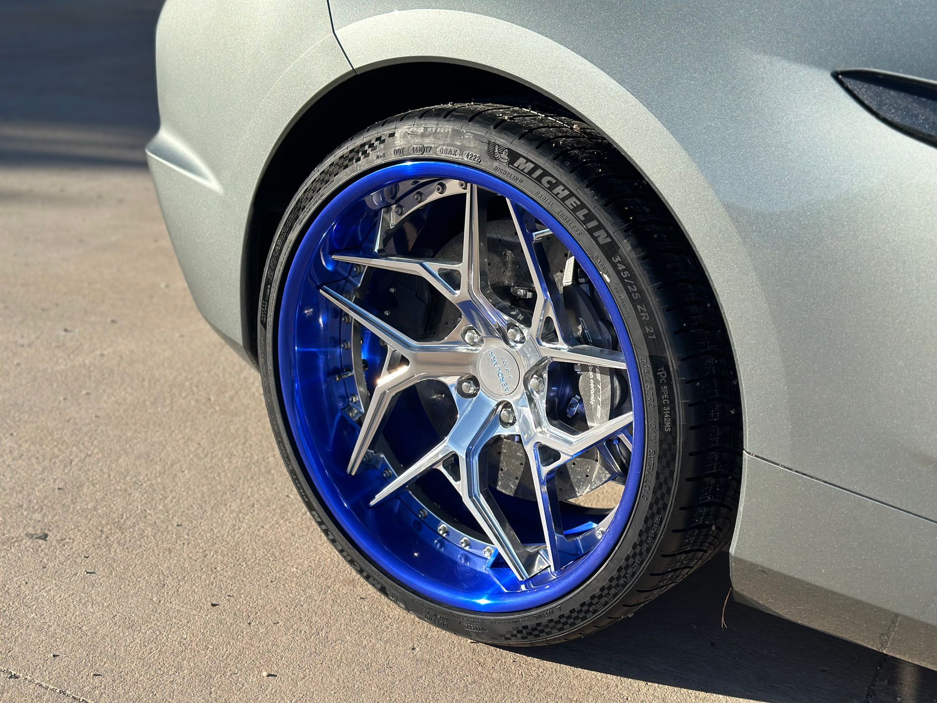 a close up of a car wheel with a blue tire