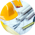 Yellow hard hat, blueprints, and tools on a construction plan.