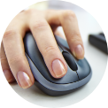 Hand with manicured nails using a dark gray computer mouse.