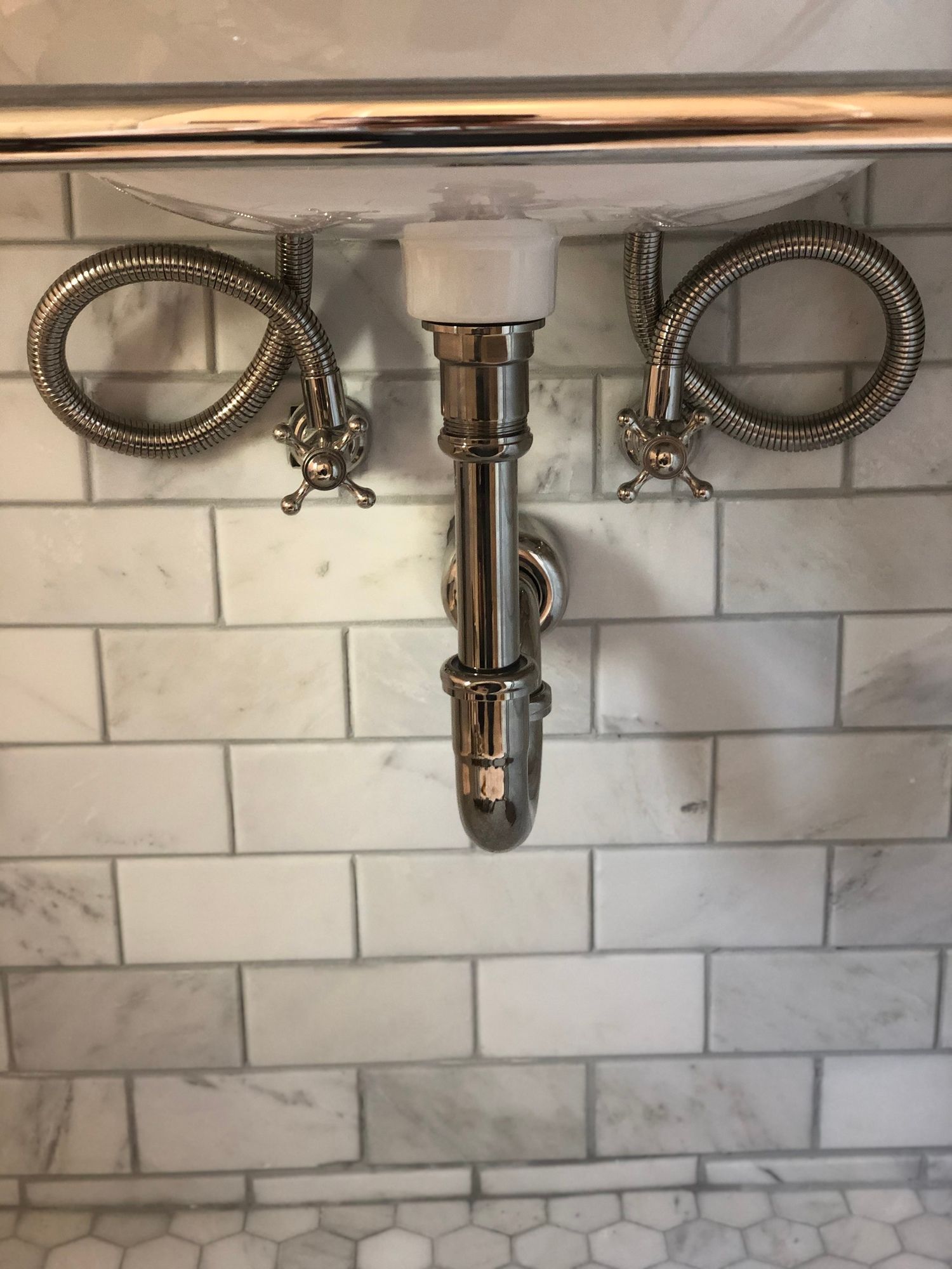 A bathroom sink with a hose attached to it