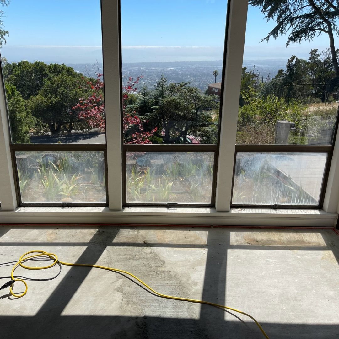 A large window with a view of a city and trees