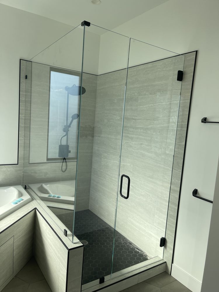 A bathroom with a walk in shower and a bathtub