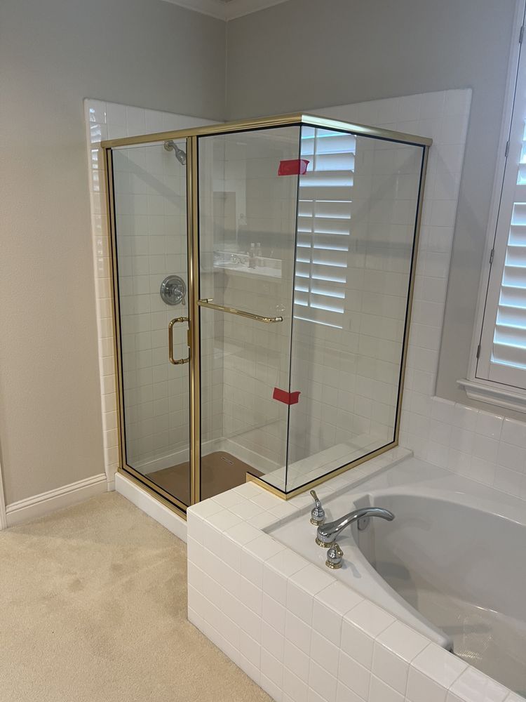 A bathroom with a shower and a bathtub.