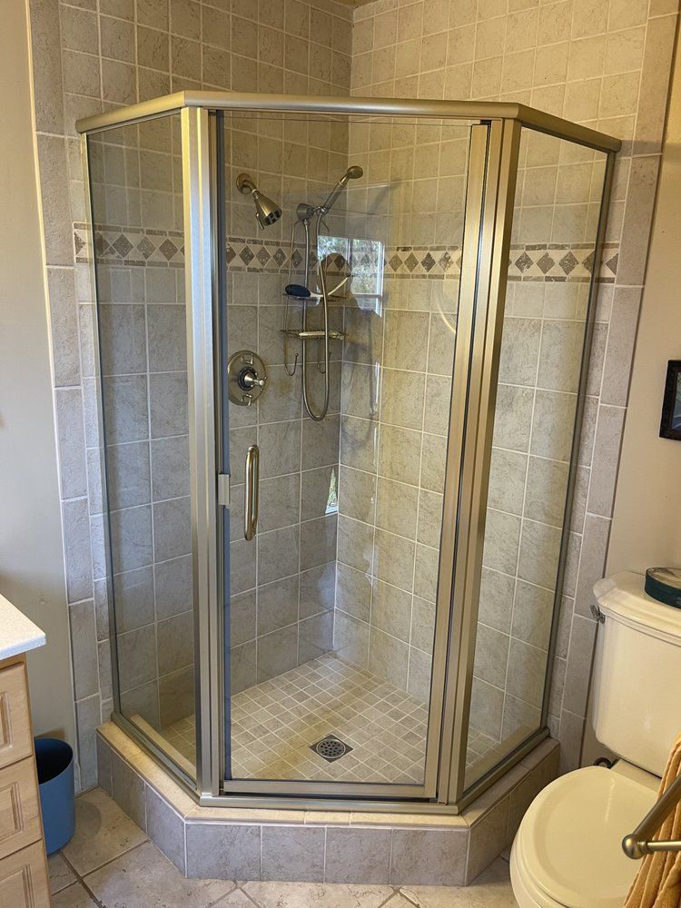 A bathroom with a shower stall and a toilet.