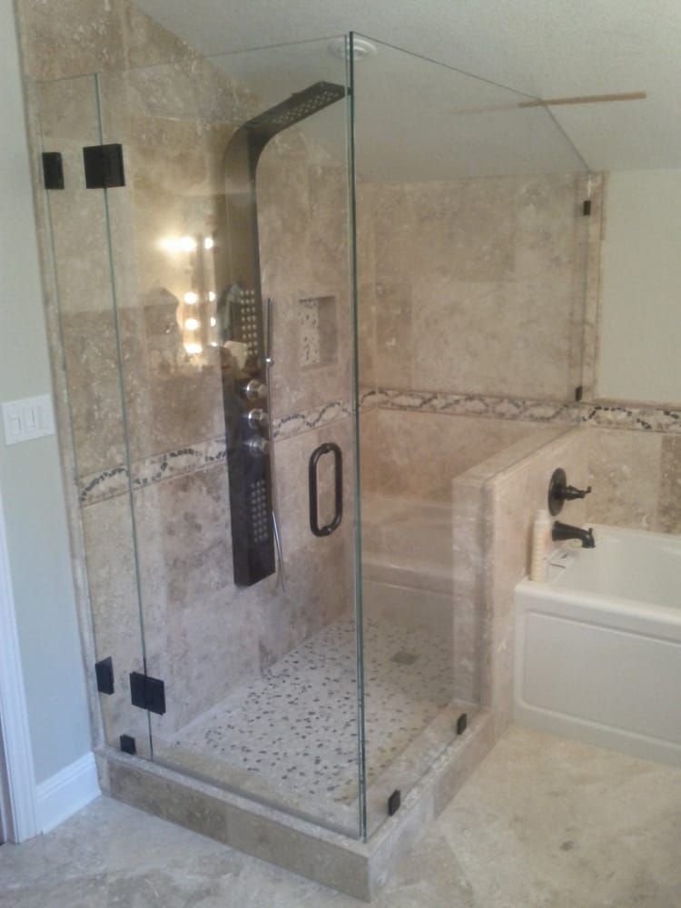 A bathroom with a walk in shower and a bathtub.