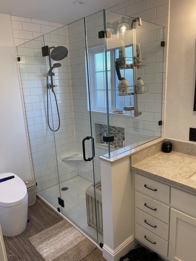 A bathroom with a walk in shower and a toilet.