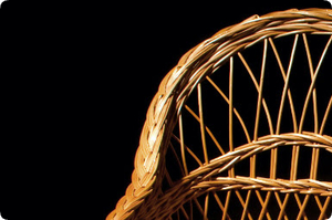 A close up of a wicker basket on a black background