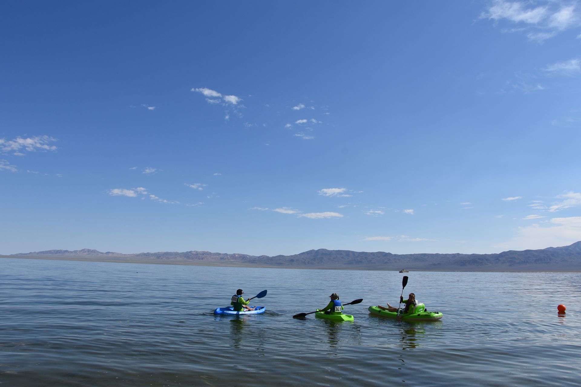 A group of people are kayaking on a lake.