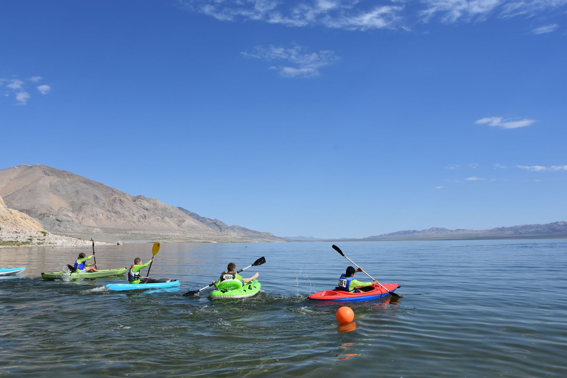 A group of people are kayaking on a lake.