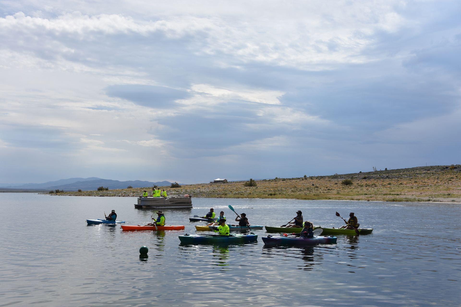 A group of people are kayaking on a lake.
