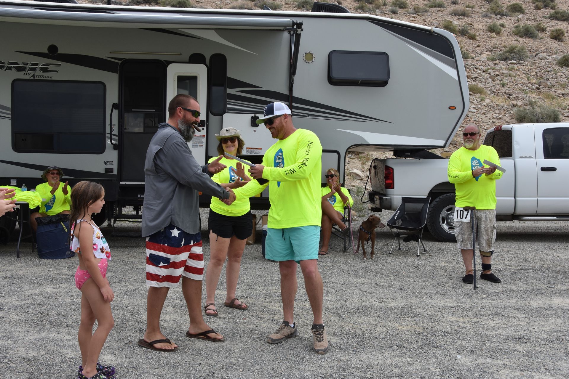 A group of people are standing in front of a trailer.