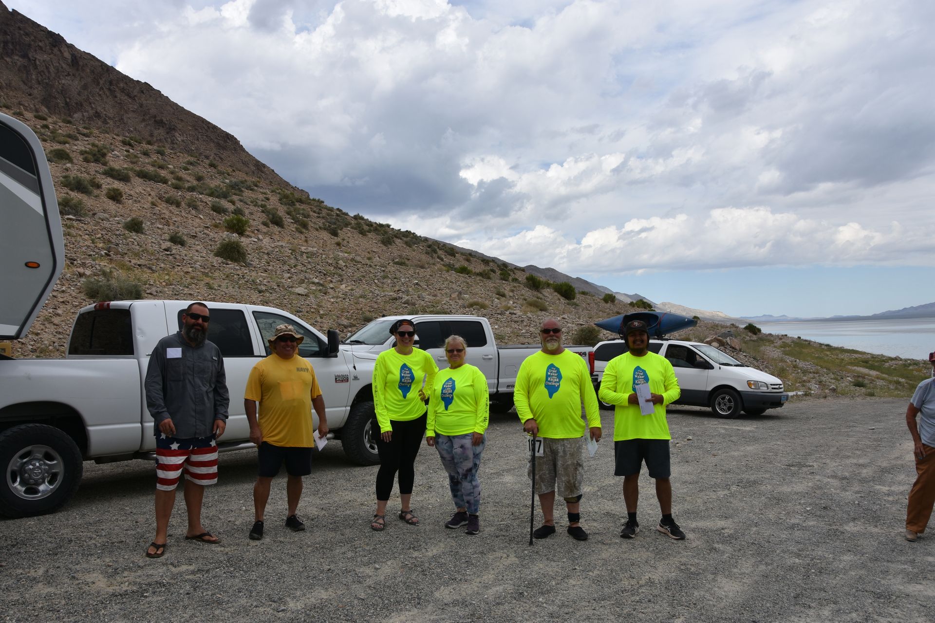 A group of people are standing in front of a truck.