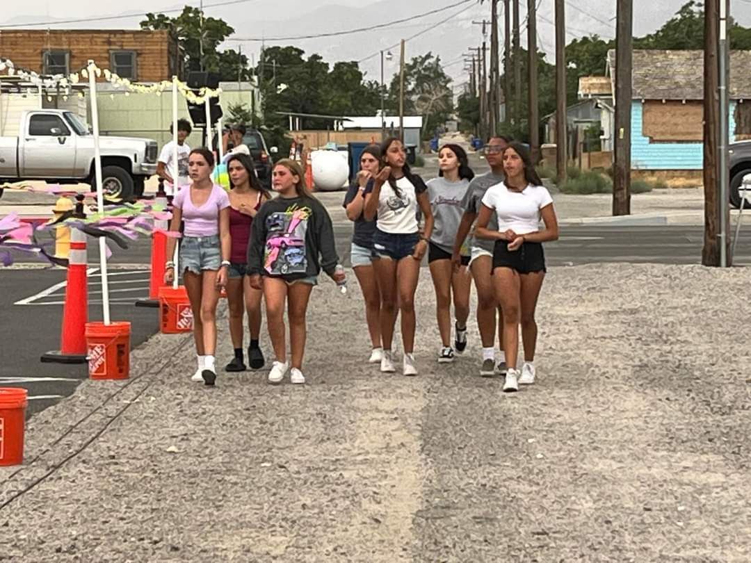 A group of young women are walking down a street.