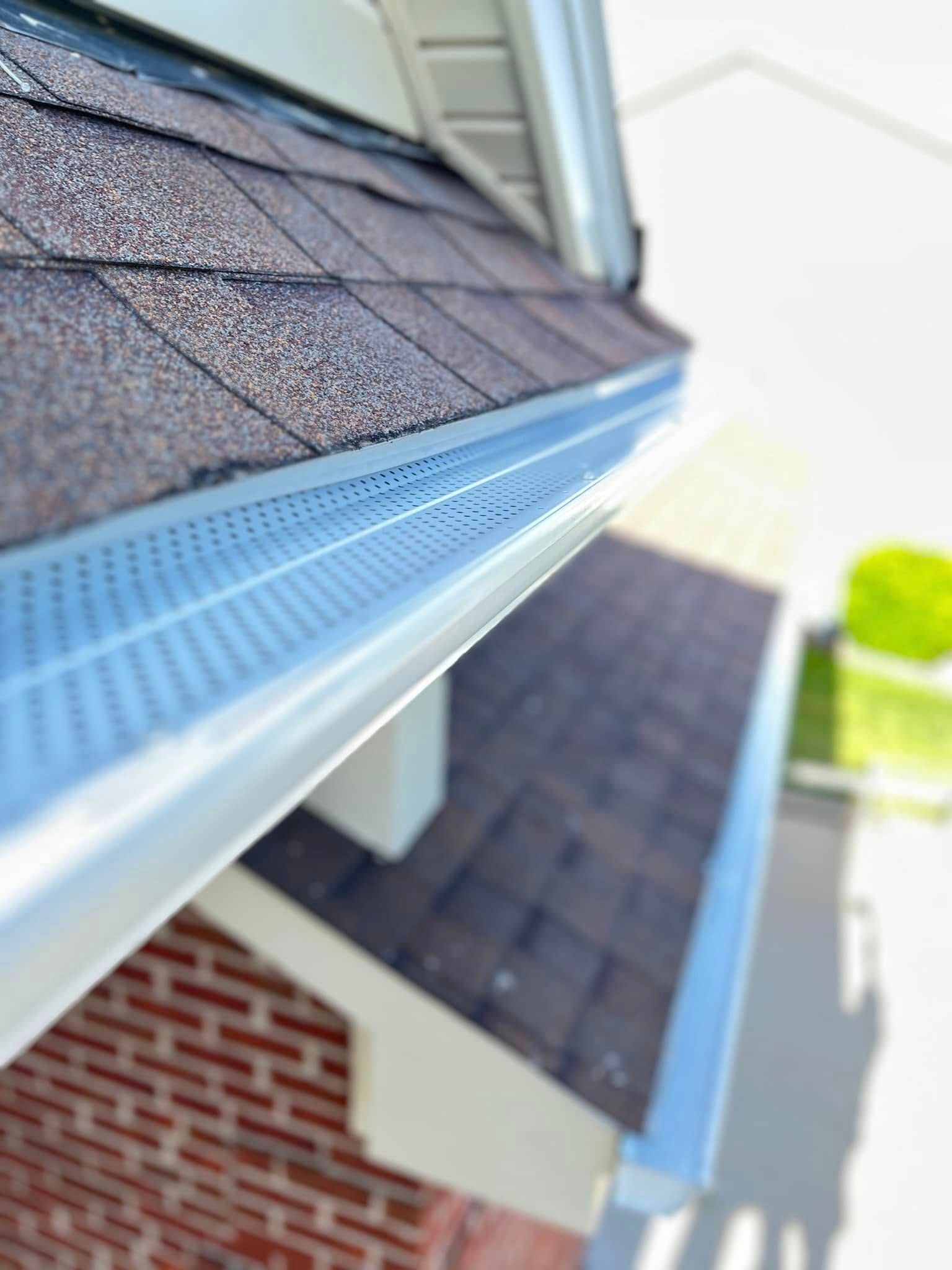 A close up of a gutter on the side of a house