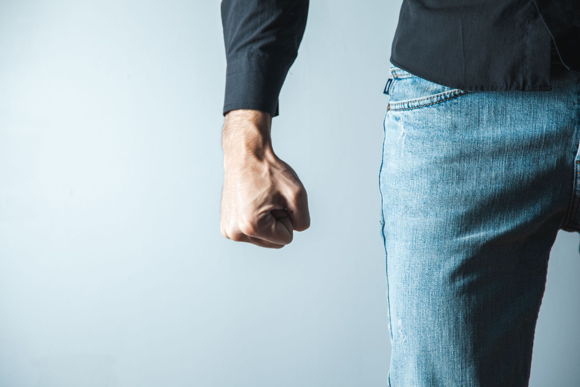 A man's clenched fist showing anger as part of the grieving process