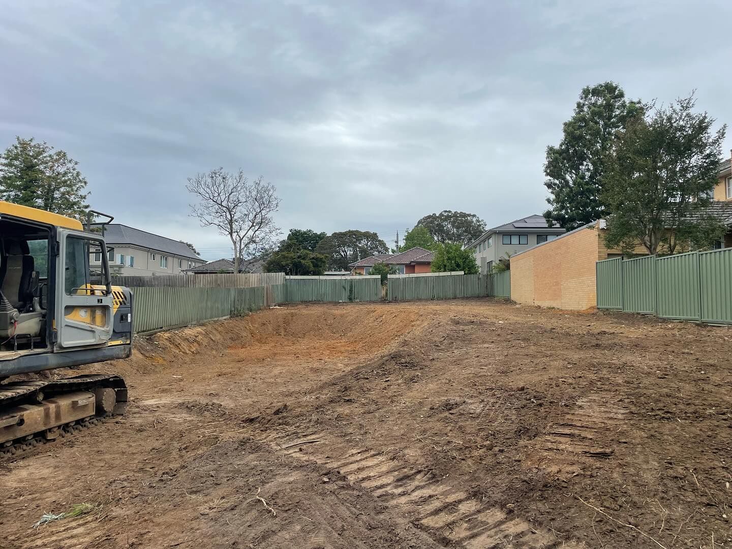 A bulldozer is sitting in the middle of a dirt field.